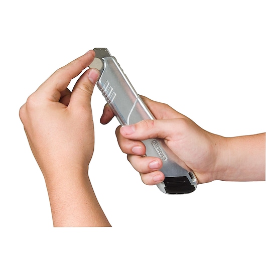Photo of STANLEY 0-10-820 utility knife held in hands, showing the blade being extended.