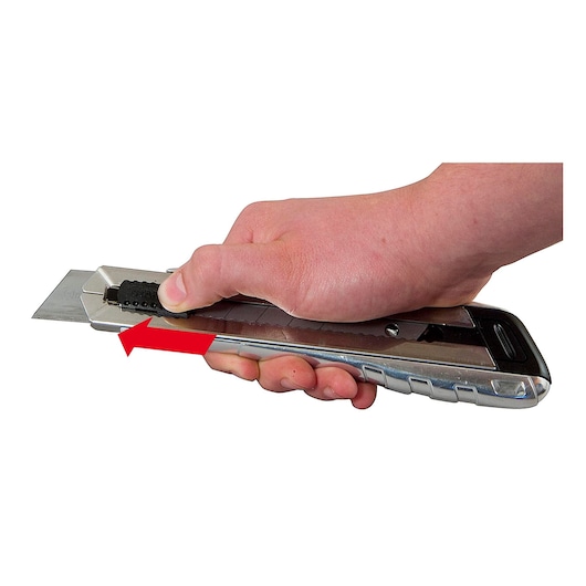 Photo of STANLEY 0-10-820 utility knife in hand, showing blade extension with a red arrow, side angle.