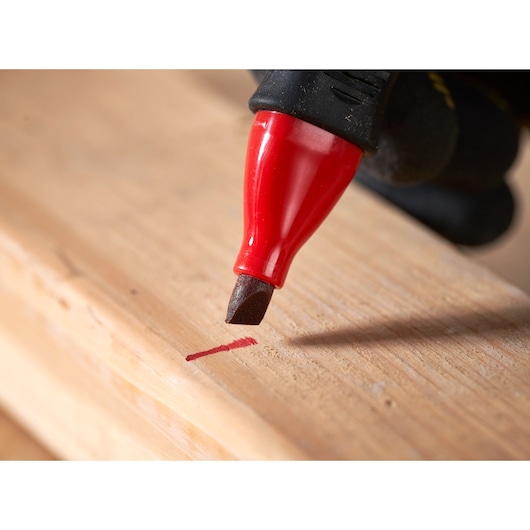 STANLEY 0-47-315 red marking pen drawing a line on wood, close-up photography.