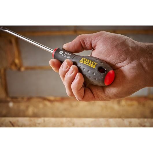Stanley 0-65-141 FATMAX screwdriver with ergonomic grip held in hand, close-up photography.