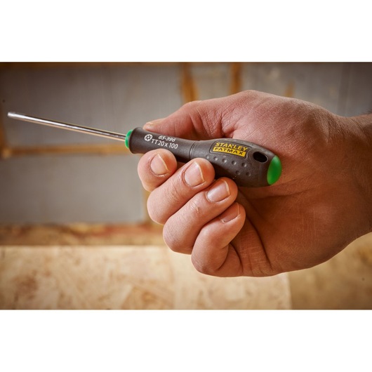 Photo of STANLEY 0-65-396 screwdriver with black and green handle, held in hand, product detail visible.