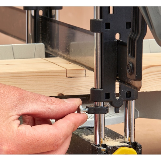 STANLEY 1-20-800 photography of a hand adjusting a bandsaw guide on a piece of wood, close-up angle.
