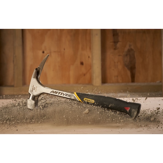STANLEY 1-51-937 claw hammer with AntiVibe grip in use on construction site.