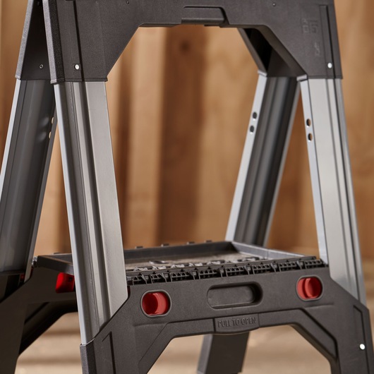 STANLEY 1-92-980 step ladder, side angle, black and silver with red details, shown in indoor setting.