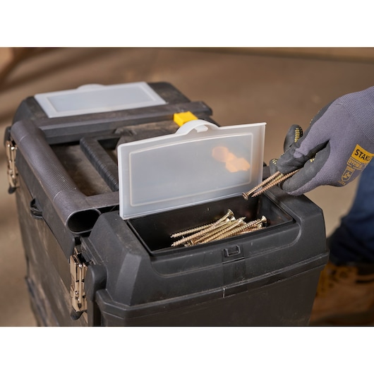 STANLEY 1-93-968 toolbox close-up with open top compartment, screws inside, gloved hand removing screws.