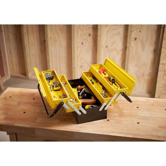 STANLEY 1-94-738 metal cantilever toolbox with yellow trays, filled with assorted hand tools, angled view.
