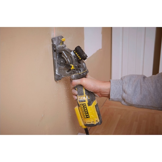 Photo of STANLEY FME380K wall chaser in use, cutting into plaster wall.
