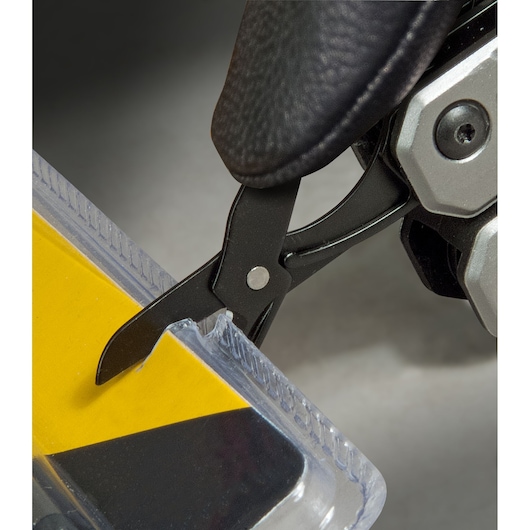 STANLEY FMHT0-72414 multi-tool scissor cutting plastic packaging, close-up photo.