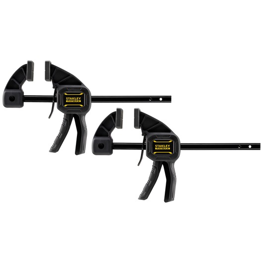 Two STANLEY trigger clamps for secure holding, black with yellow logo, suitable for woodworking or photography work.