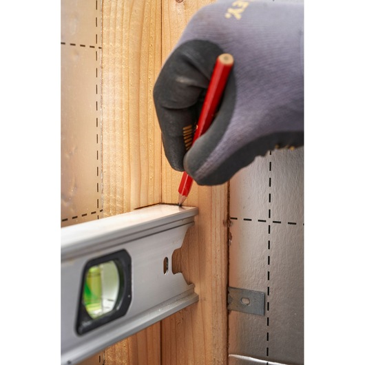 STANLEY FMHT43674-1 level used for marking on wood, close-up angle, construction photography.