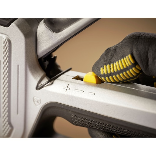 STANLEY FMHT70250-0 photography of close-up adjustment knob on a hand tool, with gloved hand using it.