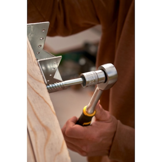 STANLEY FMMT82678-0 ratchet tool tightening bolt in metal bracket, close-up photo of STANLEY FATMAX 120-tooth ratchet.