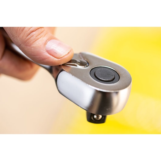 STANLEY FMMT82684-1 ratchet wrench close-up showing thumb pressing release button.
