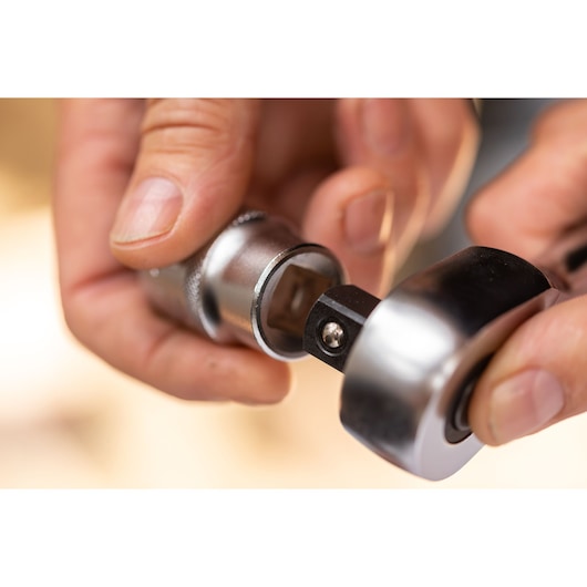 Close-up photo of STANLEY FMMT82827-1 ratchet handle connecting to a socket, product in use.