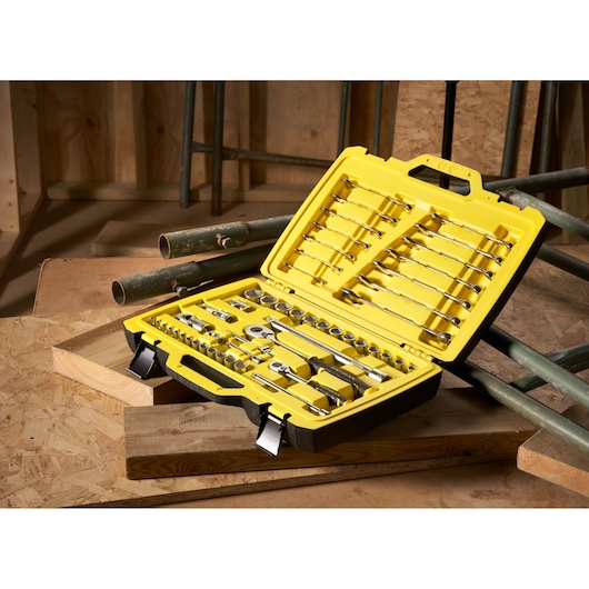 STANLEY FMMT82827-1 50-piece ratchet, socket, and combination wrench set in open yellow hard case on wood surface.