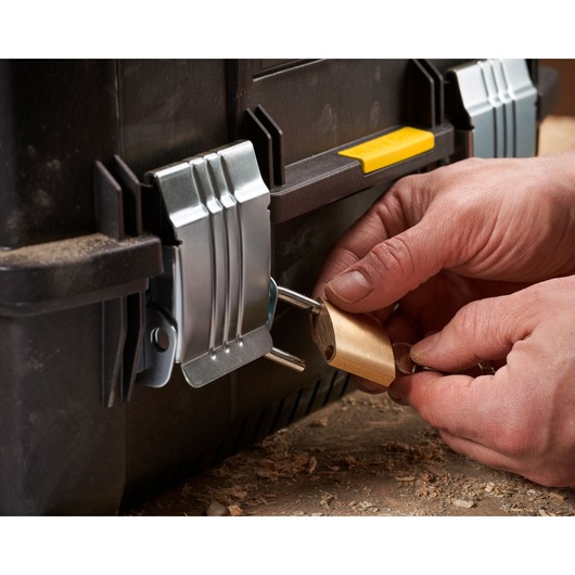 STANLEY FMST1-71219 toolbox front angle with metal latches and padlock, hands locking the latch