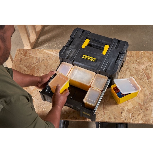 STANLEY FMST1-71968 toolbox with multiple removable yellow and clear organizer bins, photographed from above.
