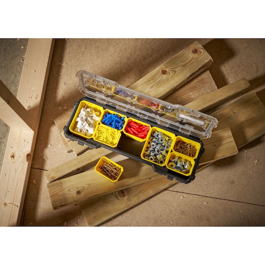 STANLEY FMST1-75781 organizer box with yellow compartments filled with assorted fasteners, top view.