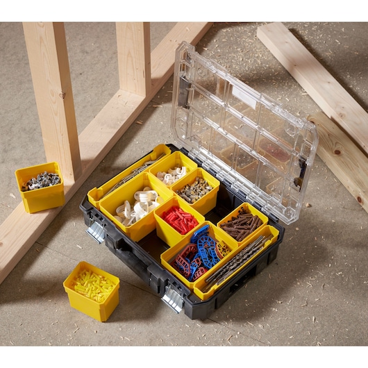 STANLEY FMST82967-1 organizer box with yellow compartments holding assorted hardware, top view.