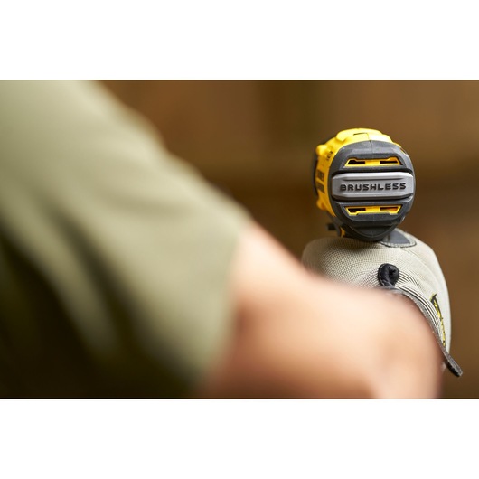 STANLEY SFMCD720B drill’s brushless motor detail, close-up photo, yellow and black tool held by gloved hand
