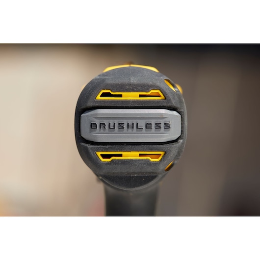 Photo of STANLEY SFMCD720D2K drill handle close-up showing 'BRUSHLESS' label, black and yellow details.
