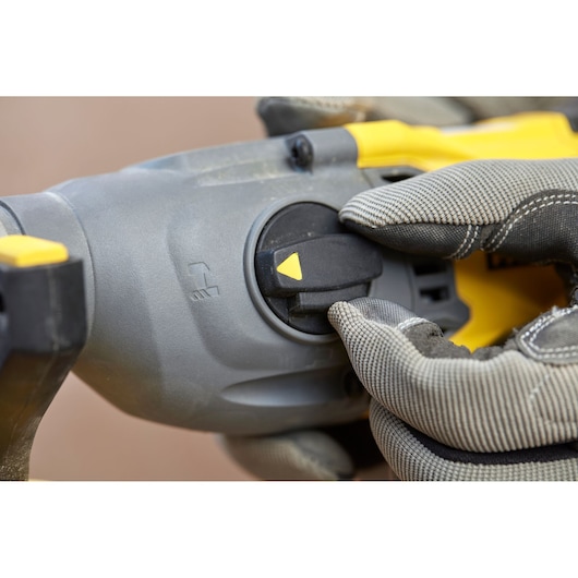 STANLEY SFMCH900M22 power tool mode selector with gloved hand adjusting, close-up view.