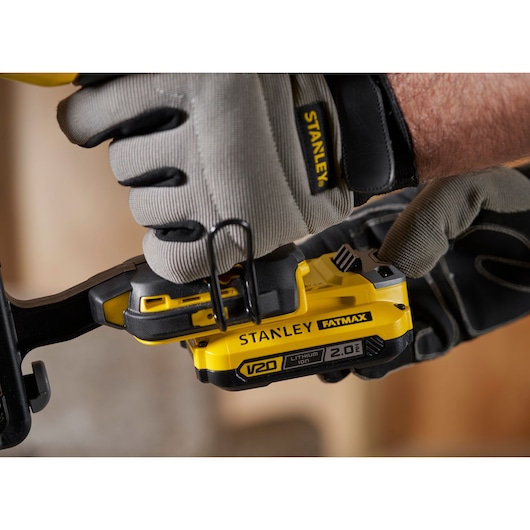 Photo of STANLEY SFMCN616B cordless tool being held, showing FATMAX V20 2.0Ah battery pack.