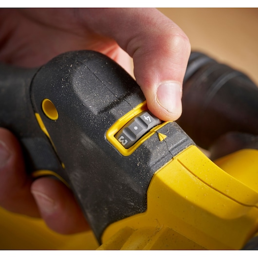 STANLEY SFMCW223B-XJ sander close-up, showing adjustable speed dial with yellow and black handle.