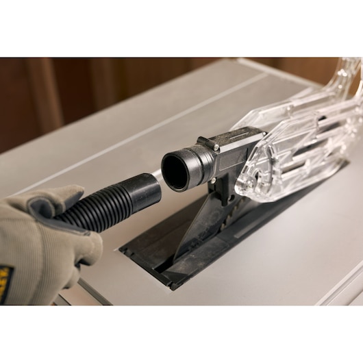 STANLEY SST1800 table saw dust port with vacuum hose connection, close-up photography.