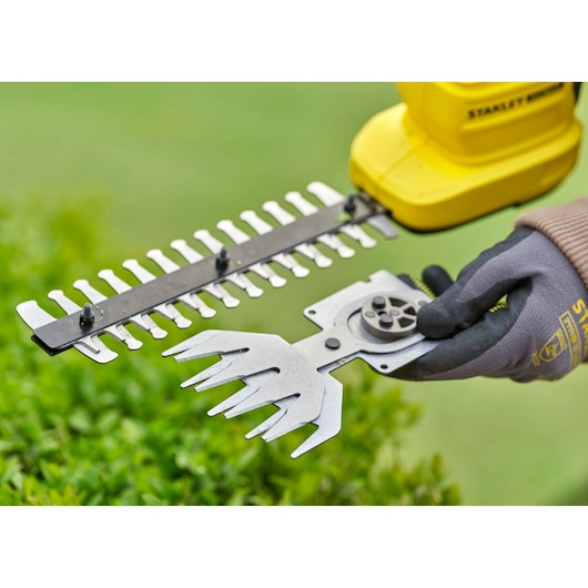 STANLEY STCSS20B hand tool with yellow body, black handle, and metal blades, close-up outdoors.