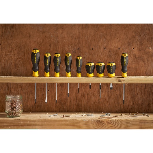 STANLEY STHT16146-0 screwdriver set with yellow and black handles, displayed upright on a wooden shelf.