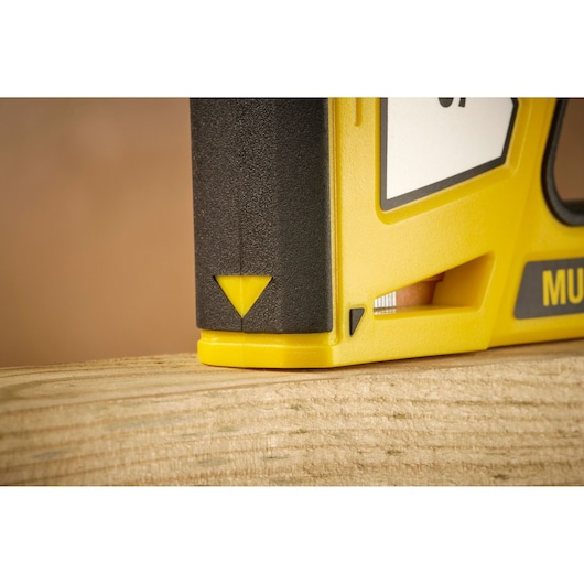 STANLEY STHT70440-0 yellow and black tool close-up on wood, photography side angle.
