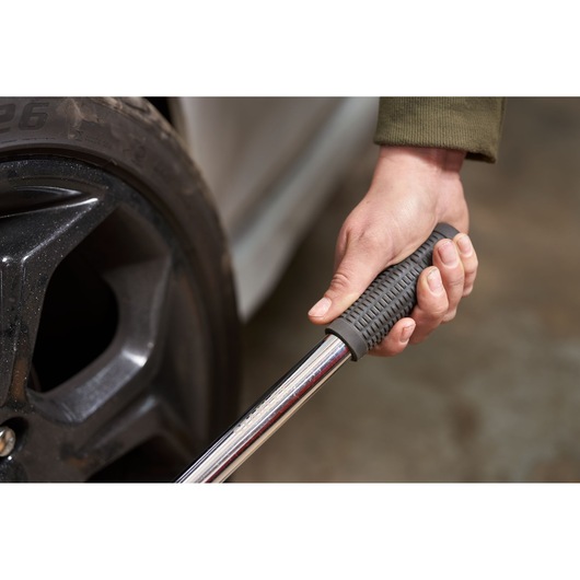 STANLEY STHT80890-0 torque wrench with textured grip, used on car wheel lug nuts, close-up photo.