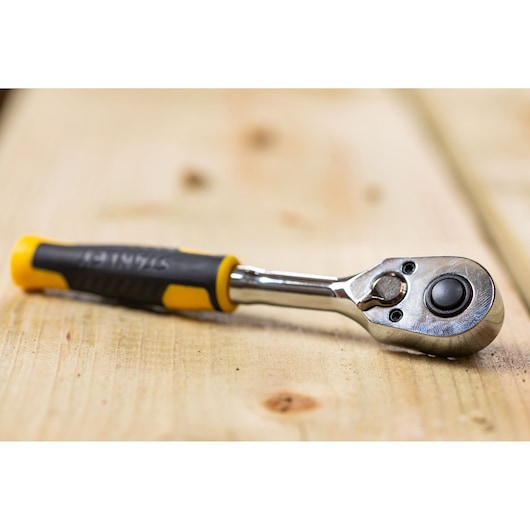 STANLEY STMT82663-0 ratchet wrench with yellow and black handle on wooden surface, product photography.
