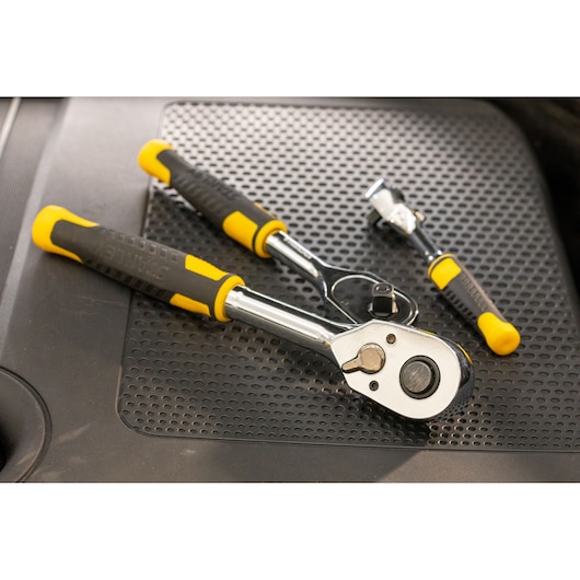 STANLEY STMT82665-0 ratchet handle set with black and yellow grips, photography from above on a textured surface.