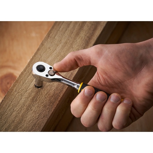 STANLEY STMT82672-0 ratchet wrench in use on a wooden beam, close-up photography.