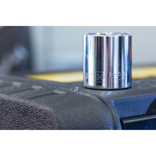 Photo of STANLEY STMT82829-1 chrome socket, close-up view on textured black surface.