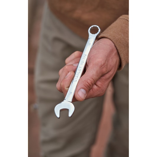 STANLEY combination wrench from STMT82843-0 set, chrome finish, held in hand, close-up photo.