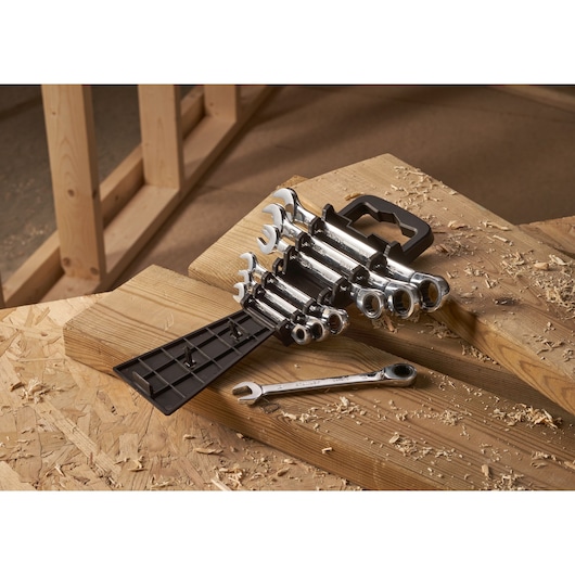STANLEY STMT82846-0 flat ratcheting wrench set, 7 pieces, on wooden workbench, angled view.