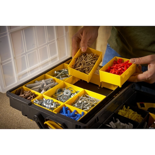 STANLEY STST1-75540 organizer box with yellow compartments holding assorted hardware, top view.