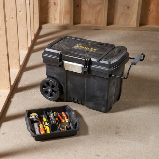 STANLEY STST33090-1 rolling toolbox with tray containing assorted hand tools, photographed in workshop.