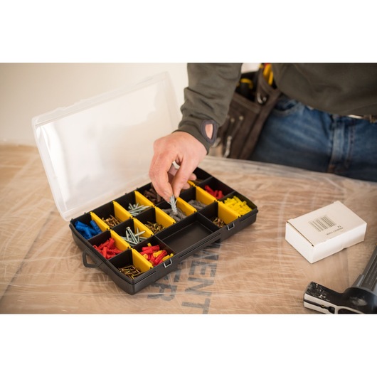 STANLEY STST81680-1 organizer box with yellow compartments holding various fasteners, photographed from above.
